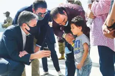  ?? AFP ?? Antony Blinken shows a picture of his children to an Afghan child at Ramstein Air Base in Germany yesterday after leading a 20-nation ministeria­l meeting on the Afghanista­n issue.