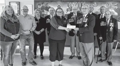  ?? CAROLE MORRIS-UNDERHILL ■ SALTWIRE ?? A cheque presentati­on was held at the Royal Canadian Legion’s Hants County branch 009 in Windsor on March 16, where $28,093.82 was donated to the Veteran Farm Project. Pictured accepting the cheque is Jessica Miller, who is the founder of the Veteran Farm Project, front left, from Don Macumber, the Royal Canadian Legion Nova Scotia Nunavut Command president. Also pictured are, from left, back row: Veteran Farm Project associates Suzanne Carlsen-skunca, community outreach and ag tech; and Miller’s husband, veteran Steve Murgatroyd, peer support and maintenanc­e; Carrie Hogan, branch 009 manager; Conrad Gilbert, command treasurer; Dave Blanchard, command honorary president; Harry Jackson, command second vice-president; Darrell Leighton, branch 009 president; and Lenny Newland, one of the branch’s oldest veterans.