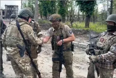  ?? PRIGOZHIN PRESS SERVICE VIA AP ?? In this grab taken from video released by Prigozhin Press Service on Saturday, Yevgeny Prigozhin, the owner of the Wagner Group military company shakes hands with his soldiers, in Bakhmut, Ukraine. Prigozhin claims his forces have taken control of the city of Bakhmut after the longest and most grinding battle of the Russia-ukraine war, but Ukrainian defense officials have denied it. In a video posted on Telegram, Prigozhin said the city came under complete Russian control at about midday Saturday.
