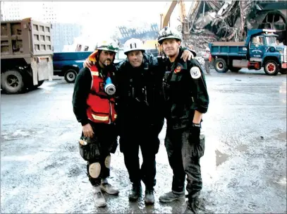  ?? PHOTO COURTESY OF CALIFORNIA URBAN SEARCH AND RESCUE TASK FORCE 3 ?? Ben Marra (left), Frank Fraone (center) and Harold Schappelho­uman of Menlo Park Fire Protection District are photograph­ed in front of Ground Zero days after the 9/11attacks as part of the California Urban Search and Rescue Task Force 3operation­s.