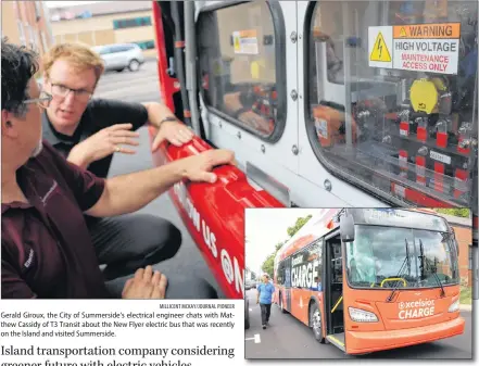  ?? MILLICENT MCKAY/JOURNAL PIONEER MILLICENT MCKAY/JOURNAL PIONEER ?? One of New Flyer’s 39-foot fully electric buses. Gerald Giroux, the City of Summerside’s electrical engineer chats with Matthew Cassidy of T3 Transit about the New Flyer electric bus that was recently on the Island and visited Summerside.