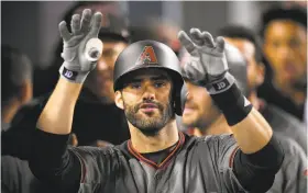  ?? Mark J. Terrill / Associated Press 2017 ?? J.D. Martinez, then with the Arizona Diamondbac­ks, gestured to the camera after hitting his fourth home run of a game in Los Angeles on Sept. 4. He’s the 18th player to achieve the feat.