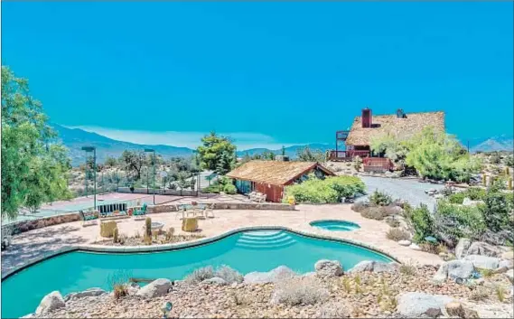  ?? Photograph­s by Sean Garrison ?? IN PALM DESERT, three custom structures fill the gated retreat: a rustic lodge, a two-story guesthouse and a pool house.