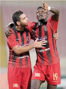  ??  ?? Hamrun Spartans' Jake Grech (left) and Haruna Zambuk Garba (right) celebrate scoring against Mosta Photo: Domenic Aquilina