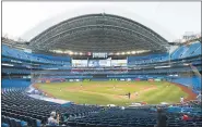  ?? NATHAN DENETTE — THE CANADIAN PRESS VIA AP ?? Photograph­ers cover the game in an empty stadium during fourth-inning intrasquad baseball game action in Toronto, Friday, July 17, 2020.