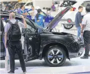  ?? PATTANAPON­G HIRUNARD ?? Visitors check out new models at the Bangkok Internatio­nal Motor Show.