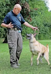  ?? [PHOTOS BY CORY YOUNG, TULSA WORLD] ?? ABOVE: Retired police dog Tibo catches a ball thrown by his partner, airport police officer Bryan Jones, on Aug. 11 at Haikey Creek Park. LEFT: Retired police dog Tibo and his partner, Bryan Jones.