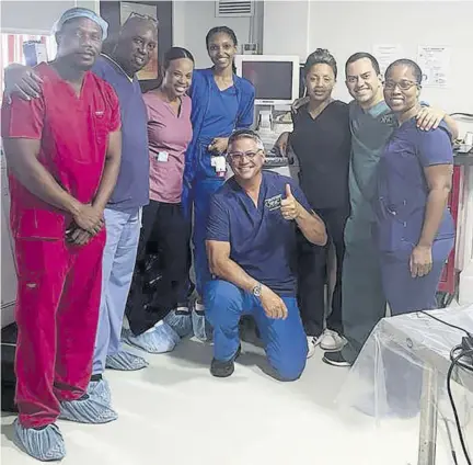  ?? ?? Partners Interventi­onal Centre of Jamaica team from left, Nurse Uchenna Obi; anaestheti­c technician Paul Findlayson; Nurse Wenice Wilson; Nurse Sada Sibbles; Hector Montes, technician from Medtronic; Dr Cleopatra Patterson; Dr Juan Agudelo; and Dr Nordia Clare-pascoe pause for a photo after successful­ly completing the first cryo-ablation therapy to treat irregular heart rhythm in Jamaica.