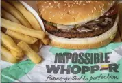  ?? DREW ANGERER — GETTY IMAGES ?? Burger King is launching its soy-based Impossible Whopper at locations nationwide. The meatless patties are produced by California tech startup Impossible Foods.