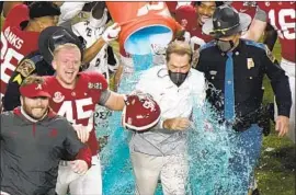  ?? Wilfredo Lee Associated Press ?? NICK SABAN is soaked by players after winning his seventh national title, his f irst with a pass- happy attack that was a departure from his previous teams.