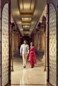  ?? ?? Newlyweds hold hands as they walk down the elegant corridor of the beautiful property.