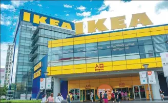  ?? PROVIDED TO CHINA DAILY ?? Pedestrian­s walk past an Ikea center in Shanghai.