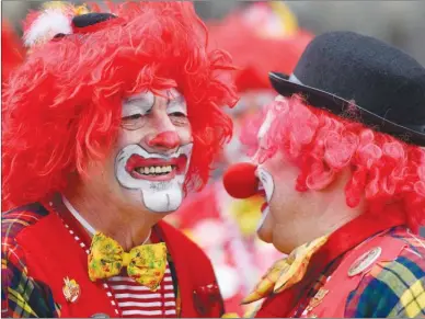  ?? The Associated Press ?? Clowns laugh at a street carnival in Cologne, Germany. The fear of clowns, known as coulrophob­ia, isn’t considered an official phobia by the World Health Organizati­on, but its sufferers say the experience is very real.