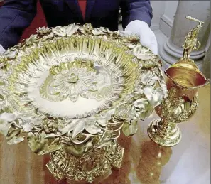  ?? — Reuters ?? royal tradition: A Crown Jeweller from the Tower of london displaying the lily Font (left) and Ewer to be used at Princess Charlotte’s christenin­g in london.