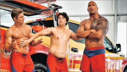  ??  ?? Zac Efron, left, with Baywatch co-stars Jon Bass and Dwayne Johnson in the film based on the popular TV series.