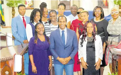  ?? CONTRIBUTE­D ?? Minister of State in the Ministry of Foreign Affairs and Foreign Trade, Alando Terrelonge (front, centre), is surrounded by staff of the Half-Way Tree Primary School, during the institutio­n’s 100th anniversar­y church service held recently at the St Andrew Parish Church in Kingston.