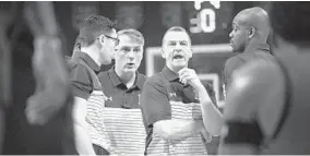  ?? PHELAN M. EBENHACK/AP ?? Maryland coach Mark Turgeon, center, talks with his staff, including Matt Brady and Mark Bialkoski (left) and DeAndre Haynes (right) during a timeout against Harvard on Friday.
