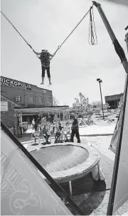  ??  ?? Ana Brown, 6, takes advantage of one of Brickopoli­s’ new attraction­s, the ultimate bungee jump.