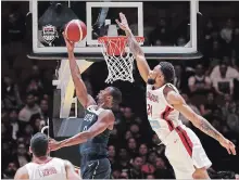  ?? RICK RYCROFT THE ASSOCIATED PRESS ?? Canada’s Khem Birch attempts to defend a layup by American Harrison Barnes during their exhibition game in Sydney, Australia, on Monday.