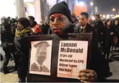  ?? | PAUL BEATY/AP ?? A protester holds a sign as people rally last Tuesday for Laquan McDonald, who was killed by CPD Officer Jason Van Dyke.