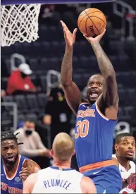  ?? Carlos Osorio / Associated Press ?? Knicks forward Julius Randle (30) takes a shot during the first half against the Pistons on Sunday in Detroit.