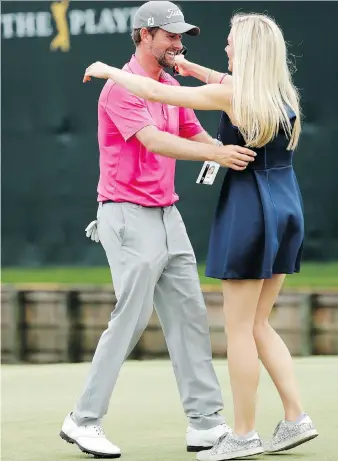  ?? JOHN RAOUOX/THE ASSOCIATED PRESS ?? Webb Simpson is greeted by wife Taylor Dowd Simpson after winning The Players Championsh­ip on Sunday. The victory moved Simpson to No. 20 in the world rankings.