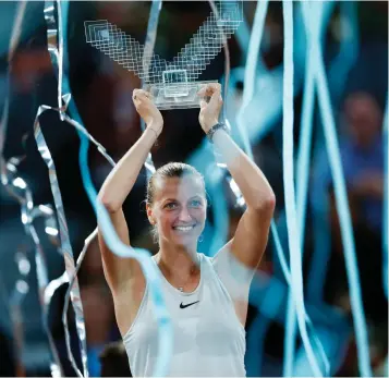  ?? Associated Press ?? ■ Czech Republic's Petra Kvitova lifts up her trophy after winning against The Netherland­s' Kiki Bertens during a Madrid Open tennis tournament final match Saturday in Madrid, Spain.