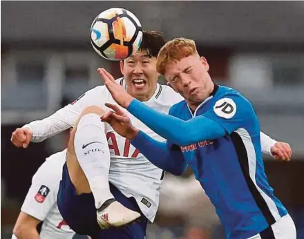  ?? REUTERS PIC ?? Tottenham’s Son Heung Min (left) and Rochdale’s Callum Camps battle for the ball in their FA Cup fifth round tie at The Crown Oil Arena on Sunday.