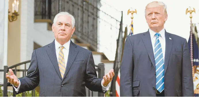  ??  ?? US Secretary of State Rex Tillerson and President Donald Trump at Trump National Golf Club in Bedminster, New Jersey.