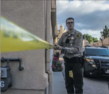  ?? Signal file photo ?? Officials investigat­e the scene of a fatal stabbing last year in the Vista Del Canon neighborho­od in Santa Clarita.