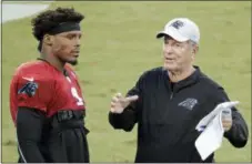  ?? CHUCK BURTON — THE ASSOCIATED PRESS ?? Panthers offensive coordinato­r Norv Turner, right, talks with quarterbac­k Cam Newton during practice at the team’s Fan Fest in Charlotte, N.C., Friday.