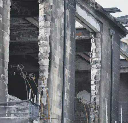  ??  ?? 0 Workmen continue to dismantle the Mackintosh building at the Glasgow School of Art this week after it was devastated by fire for a second time. Picture: Jeff J Mitchell/getty