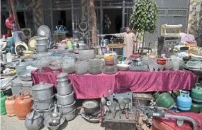  ?? — afp ?? a young shopkeeper manning his booth selling used goods at a flea market in Kabul.