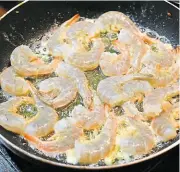  ?? ?? Sautéing commences with the prawns in a mix of olive oil and butter.