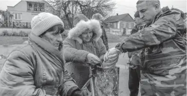  ?? FOTO: AFP ?? Habitantes de la región de Kherson, Ucrania, comparten comida.