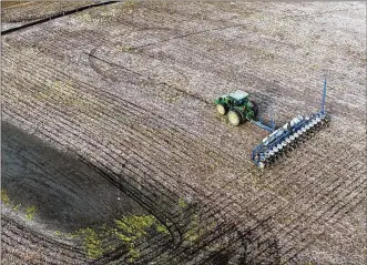  ?? TY GREENLEES / STAFF ?? A farmer in Beavercree­k avoids a wet area in the field near Shakertown Road. Storm Center 7 Chief Meteorolog­ist McCall Vrydaghs said today will be hot (high 80s) and start off dry. Around dinner time and into the early evening, the Dayton area may see strong storms.