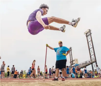  ?? MARKMIRKO/HARTFORD COURANT ?? Troy Stewart of Prince Tech flies through the air while competing in the long jump finals of the Class MTrack & Field Championsh­ips. Stewart finished fourth with a jump of 20 feet, ½ inch while Joshua Lanzieri of Seymour won with a jump of 21-10 ¾ .