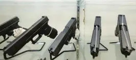  ?? ALAN DIAZ/AP ?? This June 29, 2016, file photo shows guns on display at a gun store in Miami. Florida lawmakers can fine local government officials who attempt to restrict gun and ammunition sales under a state law upheld by the state Supreme Court on Thursday.