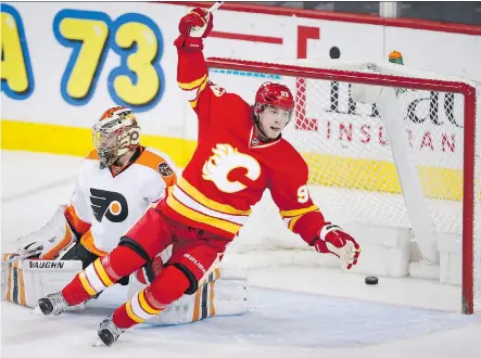  ?? JEFF MCINTOSH/THE CANADIAN PRESS ?? Sam Bennett celebrates a goal in front of Flyers goalie Michal Neuvirth Wednesday night at the Saddledome.