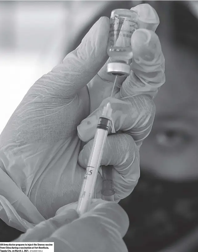  ?? AP/AARON FAVILA ?? AN Army doctor prepares to inject the Sinovac vaccine from China during a vaccinatio­n at Fort Bonifacio, Taguig City, on March 2, 2021.