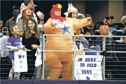  ?? ?? A fan dressed in a holiday costume dances Thursday as she and others watch the Dallas Cowboys play the Las Vegas Raiders.