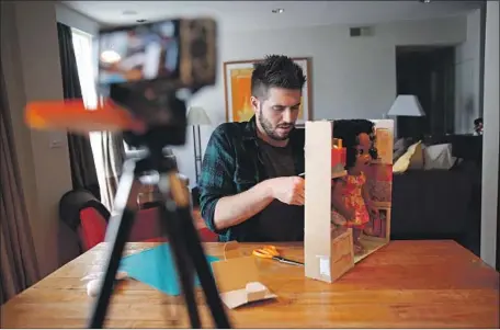  ?? Patrick T. Fallon For The Times ?? JASON ROBERT KEEF films himself unboxing a toy at his West Hollywood apartment for his “Jay Squared” YouTube channel in 2015.