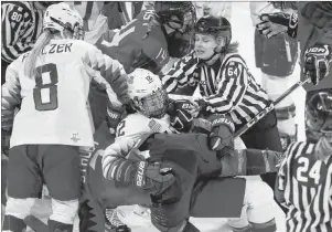  ?? AP PHOTO/JULIO CORTEZ ?? Official Jenni Heikkinen (64), of Finland, tries to separate Kelly Pannek (12), of the United States, and Laura Stacey (7), of Canada, as they scuffle during the third period of a preliminar­y round during a women’s hockey game at the 2018 Winter...