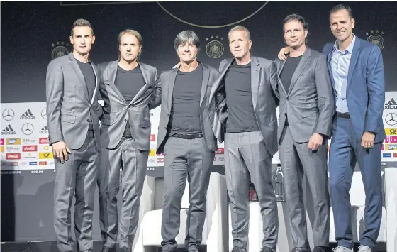  ??  ?? Germany boss Joachim Loew, third left, poses with his coaching staff.