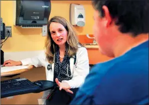  ??  ?? KIDS AND CHOLESTERO­L: Dr. Sarah de Ferranti, director of preventive cardiology at Boston Children’s Hospital, left, meets with patient Quinn Voccio, 14, of Newton, Mass., right, in Waltham, Mass., on Tuesday. A government study shows that in the past...