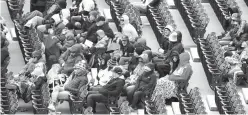  ?? Nam Y. Huh/The Associated Press ?? ■ Baseball fans are bundled up as they watch a baseball game between the Detroit Tigers and the Chicago White Sox on Sunday in Chicago.