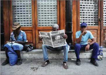  ?? PEDRO PARDO/AFP ?? A man reads a newspaper on a street in Havana on Sunday two days after the death of Cuban leader Fidel Castro.
