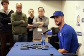 ?? GREGORY BULL - THE ASSOCIATED PRESS ?? Chicago Cubs third baseman Kris Bryant, right, speaks to reporters during spring training baseball Saturday, Feb. 15, 2020, in Mesa, Ariz.