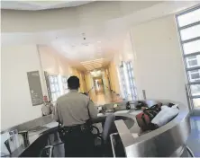  ?? Laura Morton / The Chronicle 2006 ?? Security officers keep watch over a hallway in Coalinga State Hospital, where Terrance Butler has been held since 2007.