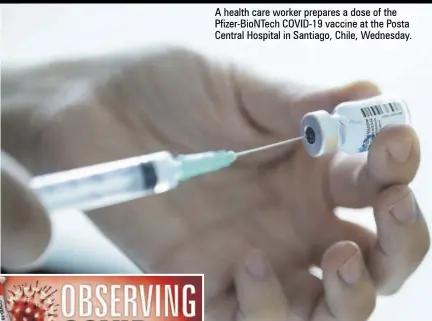  ??  ?? A health care worker prepares a dose of the Pfizer-biontech COVID-19 vaccine at the Posta Central Hospital in Santiago, Chile, Wednesday.